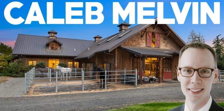 Stylish exterior of a modern barn-style home with horse paddocks, set against a twilight sky in the Pacific Northwest.