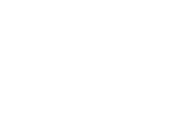 Modern exterior of a luxury home in the Pacific Northwest, showcasing sleek lines and elegant design elements against a lush green backdrop.