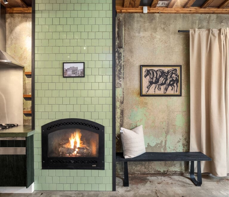 Amaryllis' Central District photography. Modern living room featuring a green tiled fireplace, exposed concrete walls, and stylish art, located in Seattle.