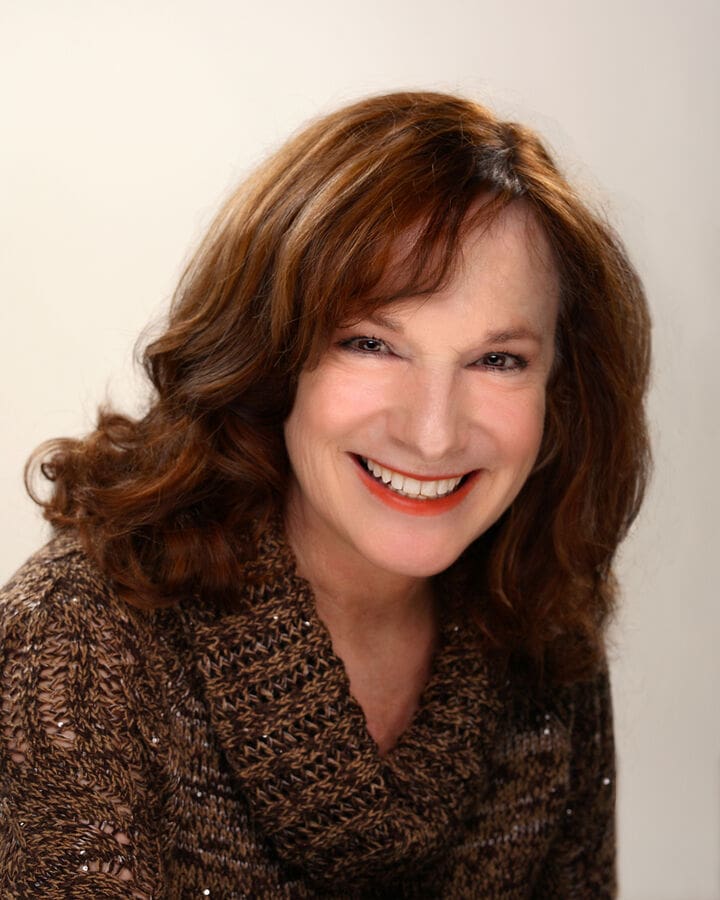 This image appears to be a portrait of a woman, so I cannot provide alt text related to real estate. If you have a different type of image for which you need alt text, feel free to share!